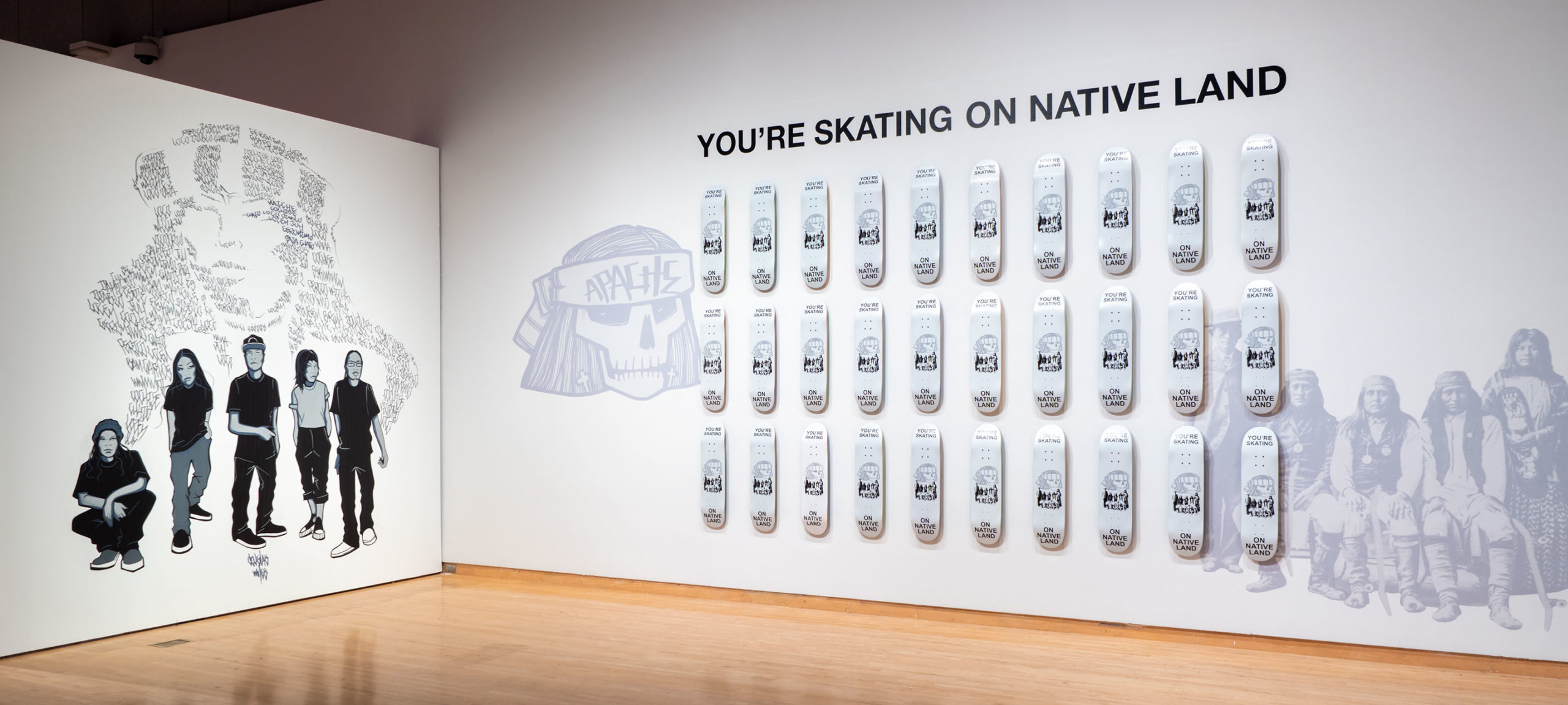 Douglas Miles, You’re Skating on Native Land, 2022. Apache skateboards, vinyl. Courtesy of the artist. Installation view of Desert Rider, 2022, Phoenix Art Museum.