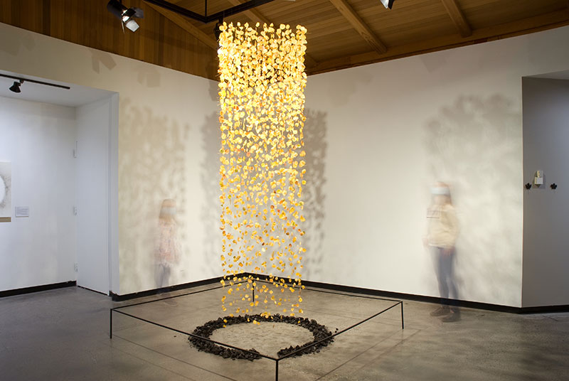 Bryan David Griffith, Rebirth, 2021. Aspen leaves preserved in beeswax, burned conifer debris from fire site. 60 x 60 x 120 inches. Courtesy of the artist.