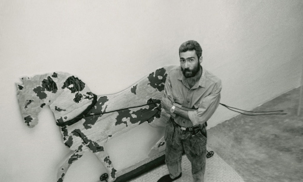 Juan Francisco Elso with his artwork Caballo contra colibrí, c. 1987-88. Fondo Magali Lara / Elso Padilla, Centro de Documentación. Arkheia MUAC (UNAM-DiGAV) Photo: Cristina Lobeira.